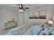 Bedroom featuring a ceiling fan, decorative pillows and a chest of drawers at 5918 Beaconpark St, Lithia, FL 33547