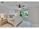 Bright bedroom with large windows, light colored walls and stylish decorations at 5918 Beaconpark St, Lithia, FL 33547