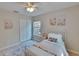 Bright bedroom featuring white trim, wood flooring, and natural light at 5918 Beaconpark St, Lithia, FL 33547