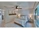 Bright bedroom featuring decorative lamps, ceiling fan, art and light flooring at 5918 Beaconpark St, Lithia, FL 33547