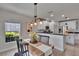 Cozy dining area featuring a stylish light fixture and an open view to the bright kitchen at 5918 Beaconpark St, Lithia, FL 33547