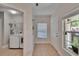 View of the entryway with tile flooring, a laundry room, and a window with natural light at 5918 Beaconpark St, Lithia, FL 33547