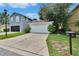 Exterior of home featuring a one-car garage with driveway and landscaping at 5918 Beaconpark St, Lithia, FL 33547
