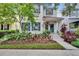 Charming home featuring a blue front door, shutters, and lush, colorful landscaping at 5918 Beaconpark St, Lithia, FL 33547