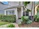 Inviting home exterior with a trimmed hedge, verdant plants, and a charming covered entranceway at 5918 Beaconpark St, Lithia, FL 33547