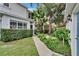 Well-maintained home featuring a lush green lawn, tidy landscaping, and a connecting walkway at 5918 Beaconpark St, Lithia, FL 33547