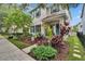 Charming two-story home with colorful landscaping, stucco exterior, and blue shutters, creating an inviting curb appeal at 5918 Beaconpark St, Lithia, FL 33547