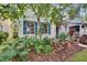 The home's exterior is surrounded by vibrant tropical landscaping and mature trees at 5918 Beaconpark St, Lithia, FL 33547