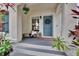 A cozy front porch features a welcome wreath, bench, and plants at 5918 Beaconpark St, Lithia, FL 33547
