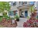Inviting front porch with a charming blue door, colorful plants, and welcoming decor at 5918 Beaconpark St, Lithia, FL 33547