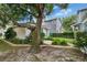 Charming home with a beautifully landscaped front yard featuring a mature tree and lush plantings at 5918 Beaconpark St, Lithia, FL 33547