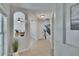 Hallway that leads to the stairs and office space, offering neutral colors and natural light at 5918 Beaconpark St, Lithia, FL 33547