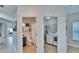 Hallway view of the half bathroom and laundry room with white washer and dryer at 5918 Beaconpark St, Lithia, FL 33547