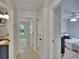 Bright hallway with wood floors and open doorways to other rooms at 5918 Beaconpark St, Lithia, FL 33547