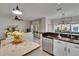 Bright, open kitchen featuring an island and seamless flow into the adjacent living area at 5918 Beaconpark St, Lithia, FL 33547