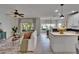 Spacious living room open to the kitchen featuring a neutral color palette and lots of natural light at 5918 Beaconpark St, Lithia, FL 33547