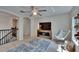 Upstairs loft space with ceiling fan, modern wood flooring, and views of staircase at 5918 Beaconpark St, Lithia, FL 33547