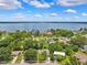 Stunning aerial view of lakefront homes surrounded by mature trees, highlighting the community's natural beauty at 602 Timber Bay W Cir, Oldsmar, FL 34677