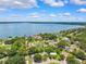 Scenic aerial view of waterfront homes on the coast with lush landscaping and a calm bay at 602 Timber Bay W Cir, Oldsmar, FL 34677