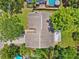 Overhead view of a residential home, showcasing its roof, backyard, and surrounding greenery at 602 Timber Bay W Cir, Oldsmar, FL 34677