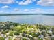 Beautiful aerial view featuring a lakefront community with lush greenery and serene waterfront homes at 602 Timber Bay W Cir, Oldsmar, FL 34677