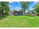Beautiful backyard featuring a screened-in porch and plenty of grassy area, perfect for relaxing or entertaining at 602 Timber Bay W Cir, Oldsmar, FL 34677