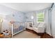 This is a Bedroom featuring a crib, changing table and rocking chair at 602 Timber Bay W Cir, Oldsmar, FL 34677