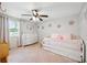 This bedroom has a ceiling fan and decoratative flower ornaments at 602 Timber Bay W Cir, Oldsmar, FL 34677