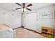 This bedroom features a ceiling fan, closet and decoratative flower ornaments at 602 Timber Bay W Cir, Oldsmar, FL 34677