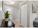 Inviting entryway features wood-look flooring, a coat closet, and modern lighting at 602 Timber Bay W Cir, Oldsmar, FL 34677
