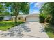 Charming one-story home with a well-manicured lawn, two-car garage, and beautiful curb appeal at 602 Timber Bay W Cir, Oldsmar, FL 34677