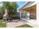 A charming backyard with a covered patio, brick grill, and lush green grass at 6658 Stewart N Ave, St Petersburg, FL 33702