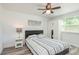 Bedroom with a ceiling fan, new floors, neutral paint, and simple, modern decor at 6658 Stewart N Ave, St Petersburg, FL 33702