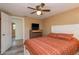 Bedroom featuring ceiling fan, new floors, neutral paint, large bed and dresser with television at 6658 Stewart N Ave, St Petersburg, FL 33702