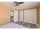 Bedroom featuring neutral paint, ceiling fan, new floors, and closet storage at 6658 Stewart N Ave, St Petersburg, FL 33702
