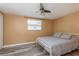 Bedroom features a ceiling fan, window, and a comfortable bed with stylish gray bedding at 6658 Stewart N Ave, St Petersburg, FL 33702