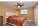 Bedroom features a large window, ceiling fan, new floors, neutral paint, and ample closet space at 6658 Stewart N Ave, St Petersburg, FL 33702
