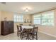 Formal dining room with a traditional table set and natural lighting from a window at 6658 Stewart N Ave, St Petersburg, FL 33702