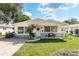 Charming single-story home with well-maintained lawn and inviting front porch seating at 6658 Stewart N Ave, St Petersburg, FL 33702
