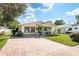 Well-kept single-story home with brick driveway and welcoming front porch seating at 6658 Stewart N Ave, St Petersburg, FL 33702