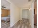 Hallway with wood-look flooring leading to bedroom and storage with a neutral color palette at 6658 Stewart N Ave, St Petersburg, FL 33702