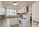 Well-lit kitchen featuring white appliances, granite countertops and a brick backsplash at 6658 Stewart N Ave, St Petersburg, FL 33702