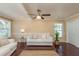 Cozy living room with hardwood floors, ceiling fan, and a comfortable sofa at 6658 Stewart N Ave, St Petersburg, FL 33702