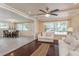 Bright living room showcasing hardwood floors, stylish sofa and access to the dining area at 6658 Stewart N Ave, St Petersburg, FL 33702