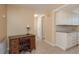Home office area with a vintage desk, chair, and storage cabinets near the kitchen at 6658 Stewart N Ave, St Petersburg, FL 33702