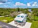 Aerial view capturing the prime location of a beautiful neighborhood near the water and lush landscape at 6679 Wander Ln, New Port Richey, FL 34652