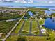 Expansive aerial view of waterfront land plots, homes, and a tranquil community setting at 6679 Wander Ln, New Port Richey, FL 34652