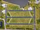 Aerial view of an aviation community with adjacent homes, boat dock and plane landing strip at 6679 Wander Ln, New Port Richey, FL 34652