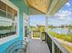 Water view from an outdoor balcony with wood floors and turquoise siding, and black railings at 6679 Wander Ln, New Port Richey, FL 34652