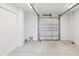 A clean, empty garage with a newly installed door and concrete floor at 6679 Wander Ln, New Port Richey, FL 34652